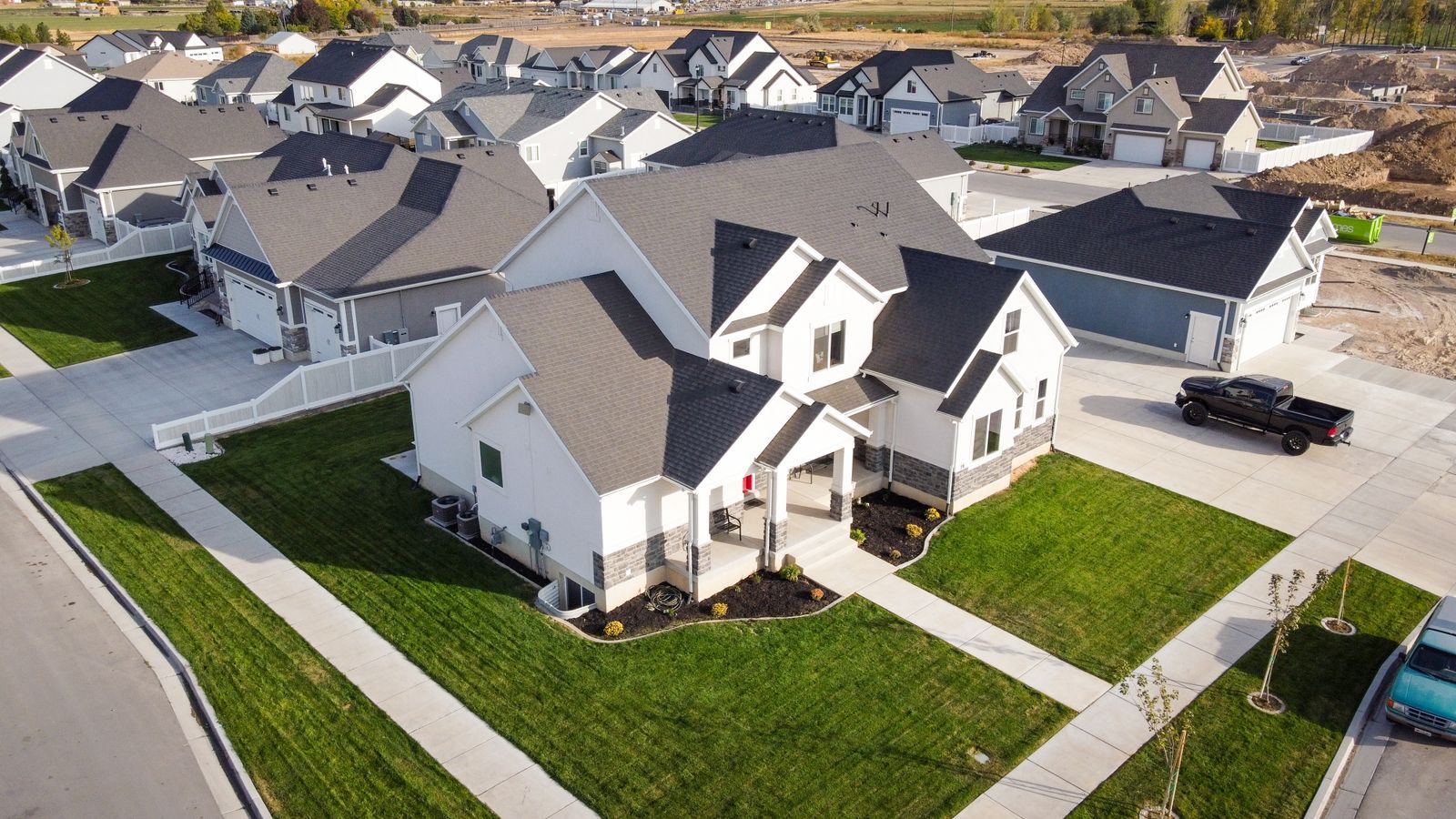 Aerial view of new two-story homes with fresh lawns and more construction beyond, much like the young neighborhoods of the City of Westlake, Florida